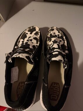 Hey Dude Black Canvas Slip-Ons with Cow Print Accents